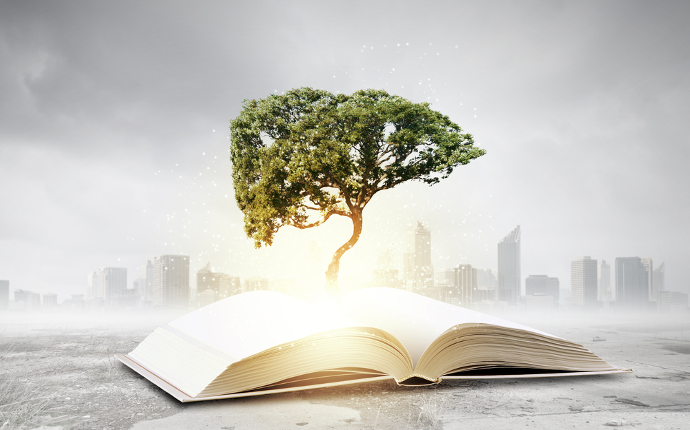 Concept of education and knowledge with tree growing from book